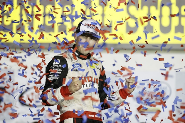 Ryan Blaney celebrates in Victory Lane after winning the NASCAR Xfinity Series auto race, Saturday, Aug. 1, 2015, at Iowa Speedway in Newton, Iowa. (AP Photo/Charlie Neibergall)