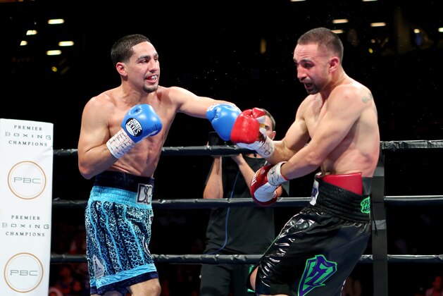 Danny Garcia, left, in action against Paul Malignaggi during their welterweight fight at the Barclays Center in Brooklyn, on Saturday, August 1, 2015. Garcia won via TKO in Round 9.  (AP Photo/Gregory Payan)