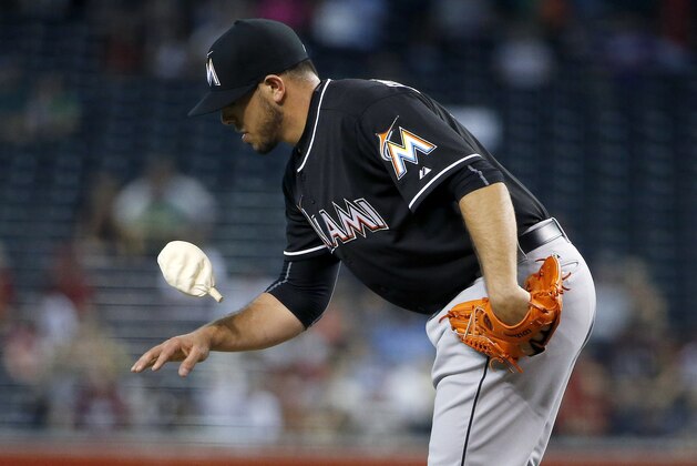 Miami Marlins' Jose Fernandez flips the rosin bag up off his hand as he warms up during the first inning of a baseball game against the Arizona Diamondbacks Wednesday, July 22, 2015, in Phoenix. (AP Photo/Ross D. Franklin)