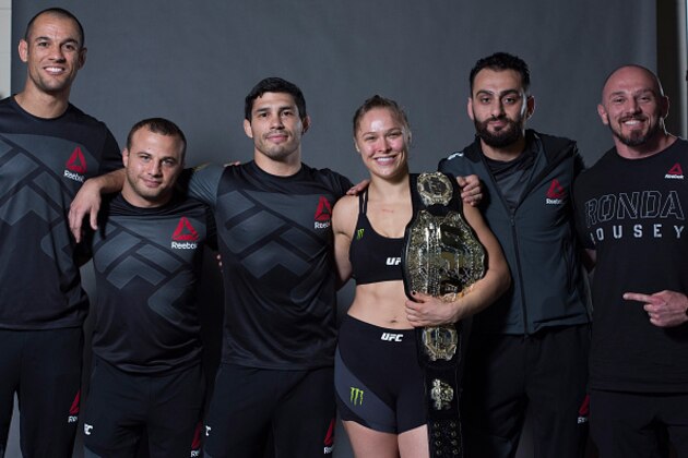 RIO DE JANEIRO, BRAZIL - AUGUST 01:  UFC strawweight champion Ronda Rousey poses for a post fight portrait backstage with her team after her victory over Bethe Correia of Brazil during the UFC 190 event inside HSBC Arena on August 1, 2015 in Rio de Janeiro, Brazil.  (Photo by Mike Roach/Zuffa LLC/Zuffa LLC via Getty Images)