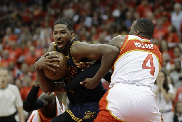 Cleveland Cavaliers center Tristan Thompson (13) moves past Atlanta Hawks forward Paul Millsap (4) during the second half in Game 2 of the Eastern Conference finals of the NBA basketball playoffs, Friday, May 22, 2015, in Atlanta. (AP Photo/David Goldman)