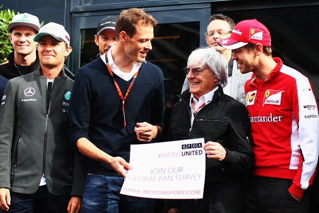 MONTE-CARLO, MONACO - MAY 21:  F1 supremo Bernie Ecclestone flanked by Toyota sportscar driver Alex Wurz (L) Sebastian Vettel (R) of Germany and Ferrari and drivers from the F1 grid promote the GPDA Fan Survey in the paddock following practice for the Monaco Formula One Grand Prix at Circuit de Monaco on May 21, 2015 in Monte-Carlo, Monaco.  (Photo by Mark Thompson/Getty Images)
