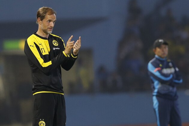 Dortmund's head coach Thomas Tuchel, left, gestures to his players during his team's test soccer match against Kawasaki Frontale in Kawasaki, south of Tokyo, Tuesday, July 7, 2015.(AP Photo/Shuji Kajiyama)