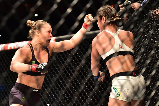 Aug 1, 2015; Rio de Janeiro, RJ, Brazil; Ronda Rousey (red gloves) fights Bethe Correia (blue gloves) during UFC 190 at HSBC Arena. Mandatory Credit: Jason Silva-USA TODAY Sports