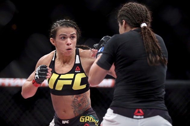 RIO DE JANEIRO, BRAZIL - AUGUST 01:  Claudia Gadelha of Brazil (red) fights Jessica Aguilar of the United States (blue) in their strawweight bout during the UFC 190 Rousey v Correia at HSBC Arena on August 1, 2015 in Rio de Janeiro, Brazil.  (Photo by Matthew Stockman/Getty Images)