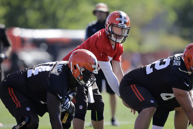 Cleveland Browns quarterback Johnny Manziel gets ready to hike the ball during practice at the NFL football team's training camp Thursday, July 30, 2015, in Berea, Ohio. (AP Photo/Tony Dejak)