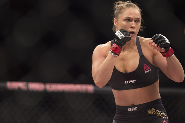 RIO DE JANEIRO, BRAZIL - AUGUST 01:  UFC women's bantamweight champion Ronda Rousey of the United States rushes forward against Bethe Correia of Brazil during the UFC 190 event inside HSBC Arena on August 1, 2015 in Rio de Janeiro, Brazil.  (Photo by Jeff Bottari/Zuffa LLC/Zuffa LLC via Getty Images)