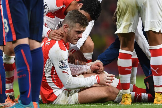 Arsenal’s Jack Wilshere sits up after being injured during the English Premier League soccer match between Arsenal and Manchester United at the Emirates Stadium, London, Saturday, Nov. 22, 2014. (AP Photo/Tim Ireland)