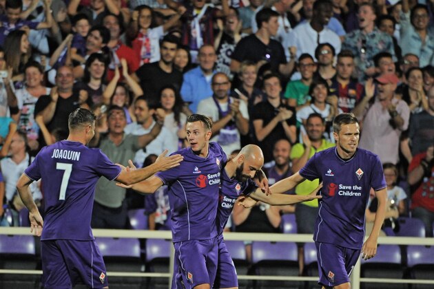 Fiorentina's Federico Bernardeschi, second left, celebrates with his teammates during an International Champions Cup soccer match between Fiorentina and Barcelona at the Artemio Franchi stadium in Florence, Italy, Sunday, Aug. 2, 2015. (Maurizio Degl'Innocenti/ANSA via AP)