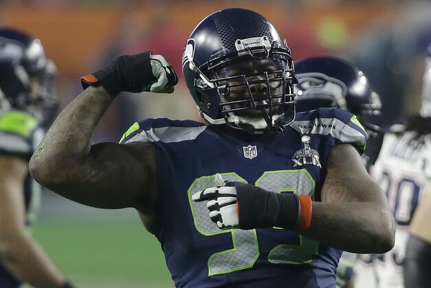 Seattle Seahawks defensive tackle Tony McDaniel (99) flexes his arm after tackling New England Patriots running back LeGarrette Blount during the second half of NFL Super Bowl XLIX football game Sunday, Feb. 1, 2015, in Glendale, Ariz. (AP Photo/Elise Amendola)