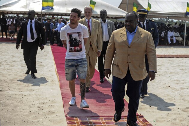 Argentinian soccer player and four-time FIFA Ballon d'Or winner Lionel Messi (C) is given a tour during the start of construction of the Port-Gentil Stadium by the President of Gabon, Ali Bongo Ondimba (R) in the Ntchengue district of Port-Gentil on July 18, 2015. Gabon will host the 2017 Africa Cup of Nations soccer tournament. AFP PHOTO / STEVE JORDAN        (Photo credit should read Steve Jordan/AFP/Getty Images)