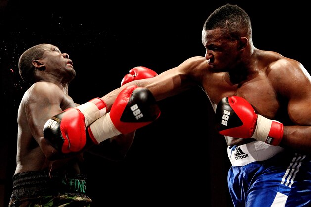 LIVERPOOL, ENGLAND - JANUARY 21:  Dillian Whyte (R) connects with Hastings Rassani during their Heavyweight bout at Liverpool Olympia on January 21, 2012 in Liverpool, England.  (Photo by Scott Heavey/Getty Images)