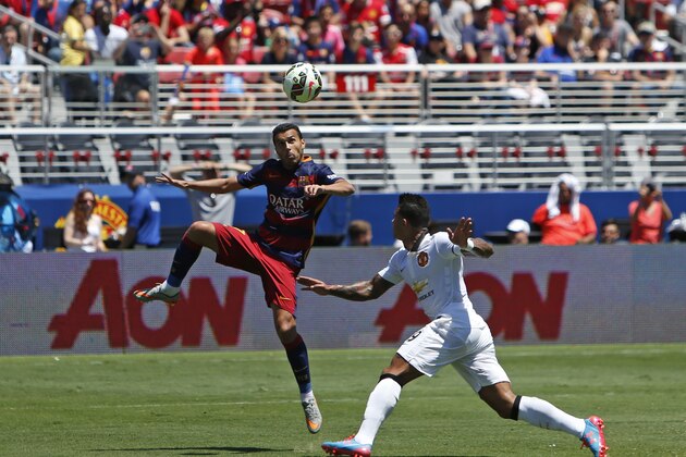 FC Barcelona's Pedro Rodriguez, left, kicks the ball as Memphis Depay defends during an International Champions Cup soccer match at Levi's Stadium, Saturday, June 25, 2015, in Santa Clara, Calif.  (Tomas Ovalle/AP Images for Relevent Sports)