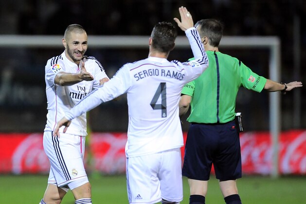 Real Madrid's Karim Benzema, left, celebrates his goal with teammate Sergio Ramos, after scoring against SD Eibar, during their La Liga soccer match, at Ipurua stadium in Eibar, northern Spain, Saturday Nov. 22, 2014. (AP Photo/Alvaro Barrientos)