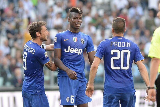 Juventus' Paul Pogba celebrates with his teammates Claudio Marchisio, left, and Simone Padoin after scoring, during a Serie A soccer match between Juventus and Cagliari at the Juventus stadium, in Turin, Italy, Saturday, May 9, 2015. (AP Photo/Massimo Pinca)