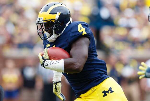 Aug 30, 2014; Ann Arbor, MI, USA; Michigan Wolverines running back De'Veon Smith (4) rushes for a touchdown in the third quarter against the Appalachian State Mountaineers at Michigan Stadium. Michigan won 52-14. Mandatory Credit: Rick Osentoski-USA TODAY Sports