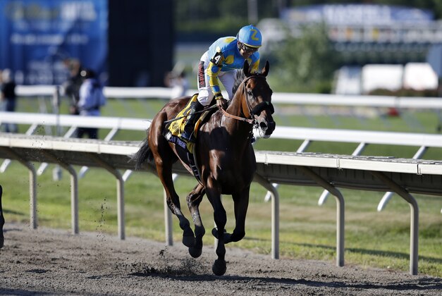 Jockey Victor Espinoza, on Triple Crown winner American Pharoah (4), wins the Haskell Invitational horse race at Monmouth Park in Oceanport, N.J., Sunday, Aug. 2, 2015. (AP Photo/Mel Evans)