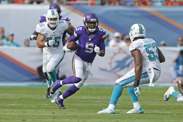 MIAMI GARDENS, FL - DECEMBER 21: Jelani Jenkins #53 and Koa Misi #55 of the Miami Dolphins defend as Teddy Bridgewater #5 of the Minnesota Vikings scrambles out of the pocket on December 21, 2014 at Sun Life Stadium in Miami Gardens, Florida. The Dolphins defeated the Vikings 37-35. (Photo by Joel Auerbach/Getty Images)