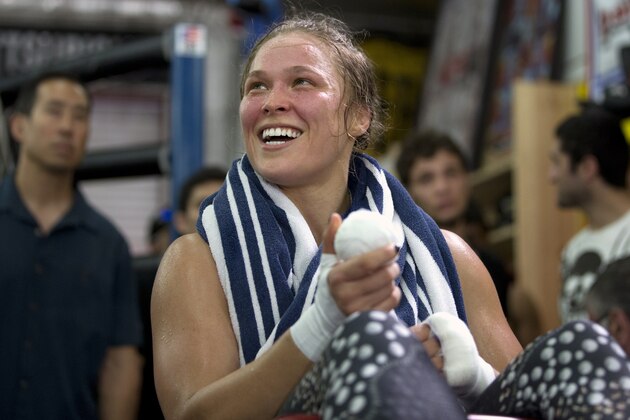 FILE - This July 15, 2015, file photo shows mixed martial arts fighter Ronda Rousey smiles during her workout at Glendale Fighting Club, in Glendale, Calif.  Rousey's star power grows with each month, and the UFC's dominant bantamweight champion could have held her next title defense anywhere. She chose to travel to Bethe Correia's native Brazil for UFC 190 on Saturday, Aug. 1 just so she can embarrass the challenger in front of her home fans.  (AP Photo/Jae C. Hong, File)