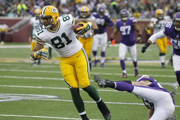 Green Bay Packers tight end Andrew Quarless (81) breaks a tackle by Minnesota Vikings free safety Harrison Smith after making a reception during the first half of an NFL football game, Sunday, Nov. 23, 2014, in Minneapolis. (AP Photo/Ann Heisenfelt)