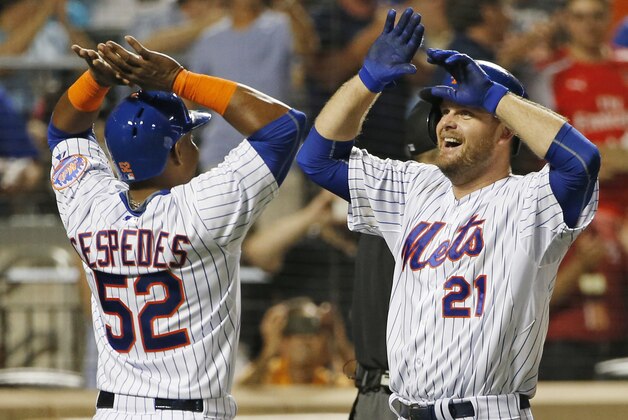 New York Mets Yoenis Cespedes, (52), greets New York Mets Lucas Duda at the plate after scoring on Duda's third-inning, two-run, home run during a baseball game against the Washington Nationals in New York, Sunday, Aug. 2, 2015. (AP Photo/Kathy Willens)