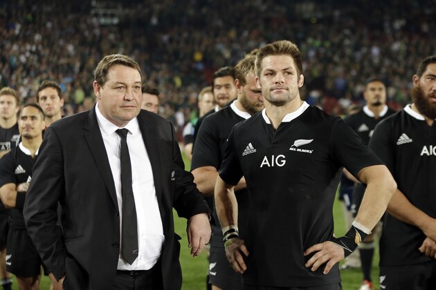New Zealand captain Richie McCaw, center, stands with coach Steve Hansen, left, after losing their Rugby Championship match against South Africa at Ellis Park stadium in Johannesburg, South Africa, Saturday, Oct. 4, 2014. South Africa beat New Zealand 27-25. (AP Photo/Themba Hadebe)