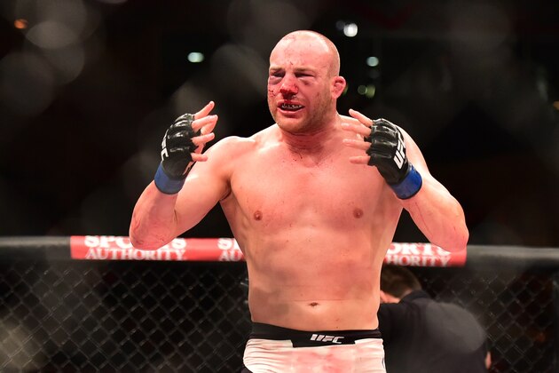 Aug 1, 2015; Rio de Janeiro, RJ, Brazil; Patrick Cummins (blue gloves)  reacts to his KO/TKO victory against Rafael Cavalcante (red gloves) during UFC 190 at HSBC Arena. Mandatory Credit: Jason Silva-USA TODAY Sports