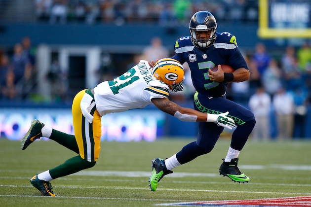 SEATTLE - SEPTEMBER 04:  Quaterback Russell Wilson #3 of the Seattle Seahawks escapes the tackle attempt of safety Ha Ha Clinton-Dix #21 of the Green Bay Packers at CenturyLink Field on September 4, 2014 in Seattle, Washington.  (Photo by Jonathan Ferrey/Getty Images)