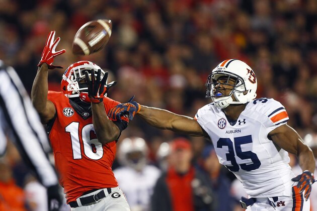 Auburn defensive back Joe Turner (35) breaks up a pass intended for Georgia wide receiver Isaiah McKenzie (16) in the first half of an NCAA college football game Saturday, Nov. 15, 2014, in Athens, Ga. (AP Photo/John Bazemore)