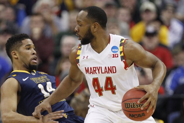 Maryland's Dez Wells (44) runs into West Virginia's Gary Browne (14) in the first half of an NCAA tournament college basketball game in the Round of 32 in Columbus, Ohio, Sunday, March 22, 2015. (AP Photo/Paul Vernon)