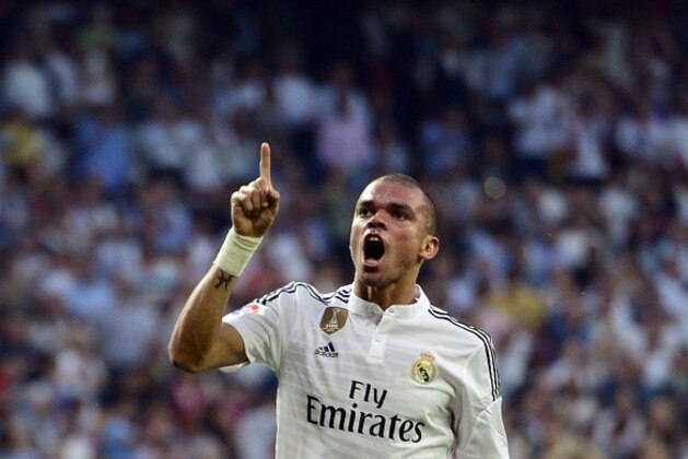 Real Madrid's Portuguese defender Pepe celebrates after scoring during the Spanish league football match Real Madrid CF vs Valencia CF at the Santiago Bernabeu stadium in Madrid on May 9, 2015.   AFP PHOTO/ GERARD JULIEN        (Photo credit should read GERARD JULIEN/AFP/Getty Images)