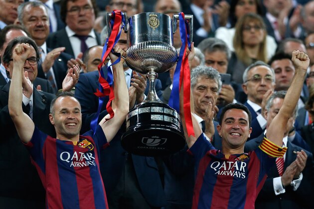 Barcelona's Andres Iniesta, left, and  Xavi Hernandez lift the trophy after winning the final of the Copa del Rey soccer match between FC Barcelona and Athletic Bilbao at the Camp Nou stadium in Barcelona, Spain, Saturday, May 30, 2015. (AP Photo/Manu Fernandez)