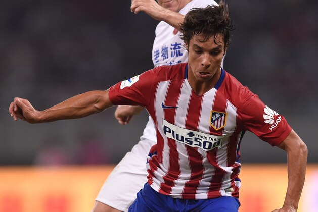 Atletico Madrid's midfielder Oliver Torres (front) and Shanghai's Argentinian forward Dario Conca vie for the ball during a friendly football match between Shanghai SIPG and Atletico Madrid in Shanghai on August 4, 2015. AFP PHOTO / JOHANNES EISELE        (Photo credit should read JOHANNES EISELE/AFP/Getty Images)