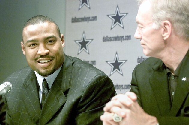Dallas Cowboys owner Jerry Jones, right, looks on as Cowboys safety Darren Woodson talks about re-signing with the team and his $20 million, five-year contract deal, at a news conference in Irving, Texas, Friday, March 1, 2002. (AP Photo/Donna McWilliam)