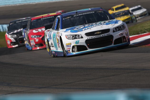 WATKINS GLEN, NY - AUGUST 10:  AJ Allmendinger, driver of the #47 Scott Products Chevrolet, leads a pack of cars during the NASCAR Sprint Cup Series Cheez-It 355 at Watkins Glen International on August 10, 2014 in Watkins Glen, New York.  (Photo by Mark Wilson/Getty Images)
