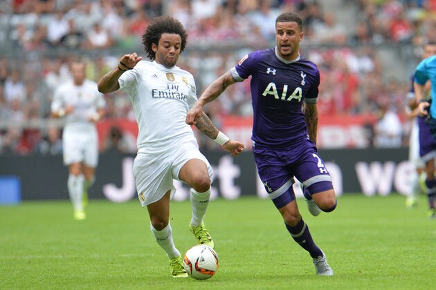 Madrid's Marcelo, left, challenge for the ball with Tottenham's Kyle Walker during  their friendly soccer match between  Real Madrid and Tottenham Hotspur, in the Allianz Arena stadium in Munich, southern Germany, Tuesday, Aug. 4, 2015. (AP Photo/Kerstin Joensson)