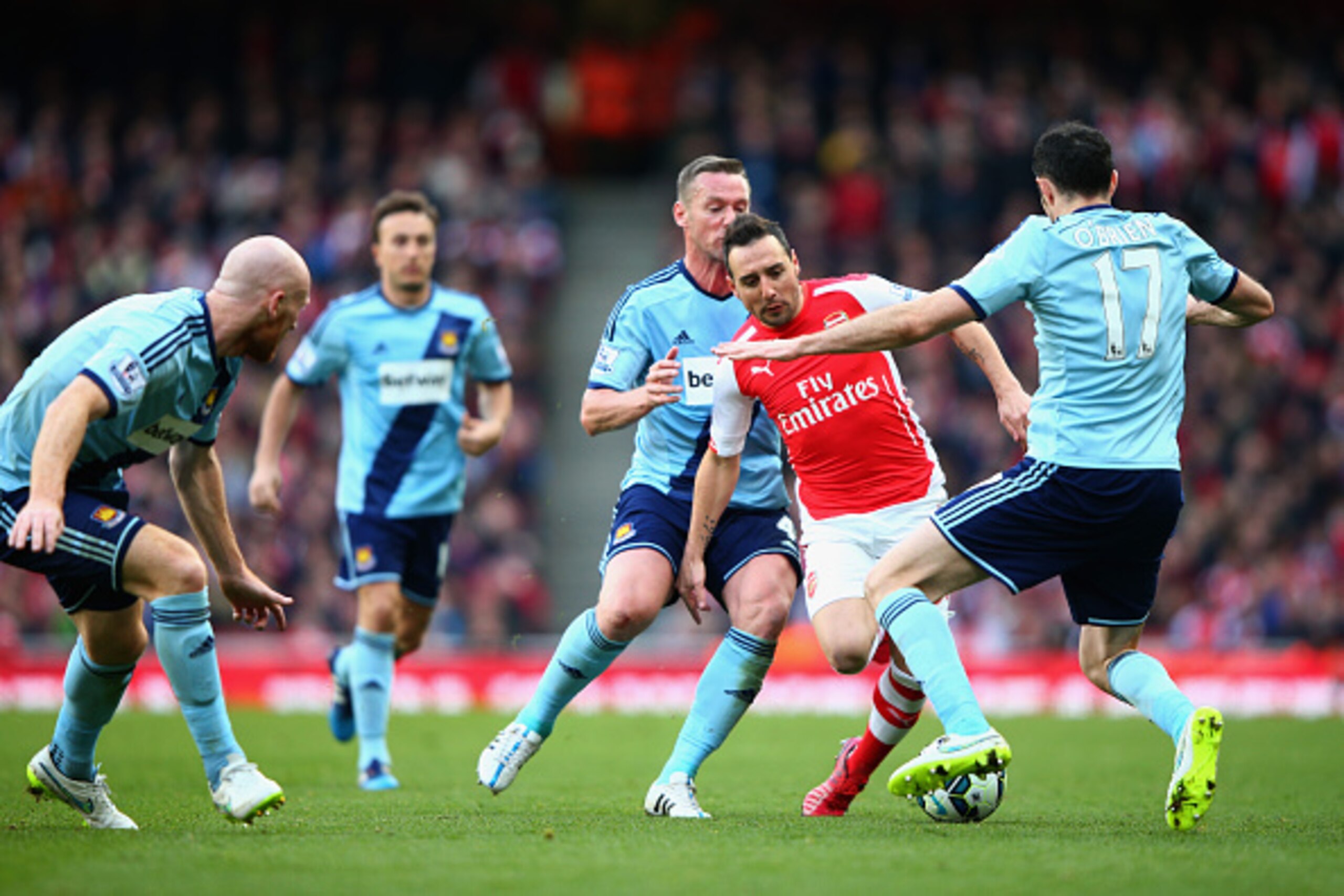 LONDON, ENGLAND - MARCH 14: Santi Cazorla of Arsenal takes on the West Ham defence during the Barclays Premier League match between Arsenal and West Ham United at Emirates Stadium on March 14, 2015 in London, England.  (Photo by Ian Walton/Getty Images)