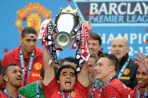 Manchester United's Brazilian defender Rafael Da Silva lifts the Premier League trophy after the English Premier League football match between Manchester United and Swansea City at Old Trafford in Manchester, northwest England, on May 12, 2013. AFP PHOTO / ANDREW YATES 

RESTRICTED TO EDITORIAL USE. No use with unauthorized audio, video, data, fixture lists, club/league logos or “live” services. Online in-match use limited to 45 images, no video emulation. No use in betting, games or single club/league/player publications        (Photo credit should read ANDREW YATES/AFP/Getty Images)