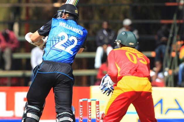 New Zealand batsman  Kane Williamson, left,  plays a shot  as Zimbabwean wicketkeeper Regis Chakabva misses a catch on the first day of the One Day International Cricket match against Zimbabwe in Harare, Sunday, Aug. 2, 2015.(AP Photo/Tsvangirayi Mukwazhi)