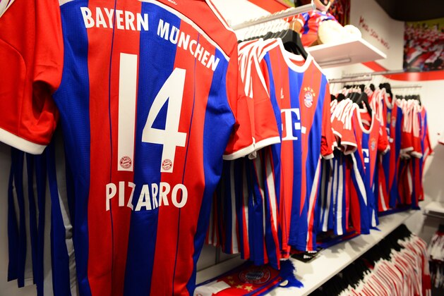 Bayern Munich team jerseys are on display in the fan shop  of German first division Bundesliga football club FC Bayern Muenchen in Berlin on November 29, 2014, during its inauguration. AFP PHOTO / JOHN MACDOUGALL        (Photo credit should read JOHN MACDOUGALL/AFP/Getty Images)