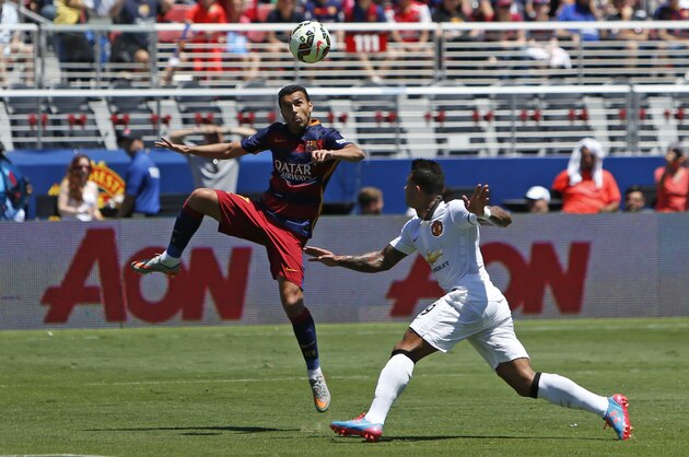 FC Barcelona's Pedro Rodriguez, left, kicks the ball as Memphis Depay defends during an International Champions Cup soccer match at Levi's Stadium, Saturday, June 25, 2015, in Santa Clara, Calif.  (Tomas Ovalle/AP Images for Relevent Sports)
