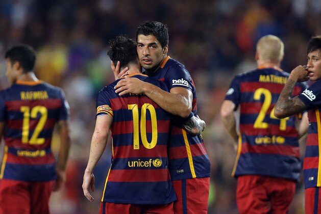 Barcelona's Luis Suarez, center, hugs teammate Lionel Messi after he scored their second goal during the Joan Gamper trophy soccer match between FC Barcelona and AS Roma at the Camp Nou stadium in Barcelona, Spain, Wednesday, Aug. 5, 2015. (AP Photo/Francisco Seco)