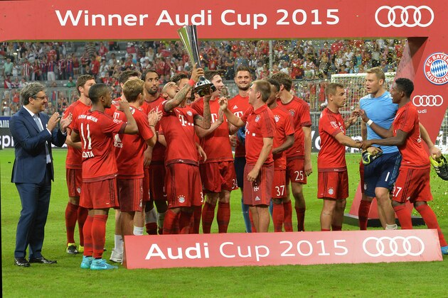 Bayern Munich players celebrate with the trophy after winning the friendly soccer match against Real Madrid in the Allianz Arena stadium in Munich, southern Germany, Wednesday, Aug. 5, 2015. (AP Photo/Kerstin Joensson)