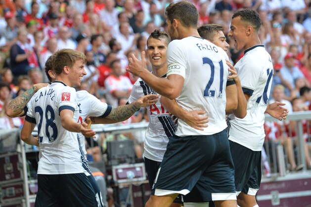 Tottenham players  celebrate a goal being scored, during the friendly soccer match between AC Milan and Tottenham Hotspur, in the Allianz Arena stadium in Munich, southern Germany, Wednesday, Aug. 5, 2015. (AP Photo/Kerstin Joensson)