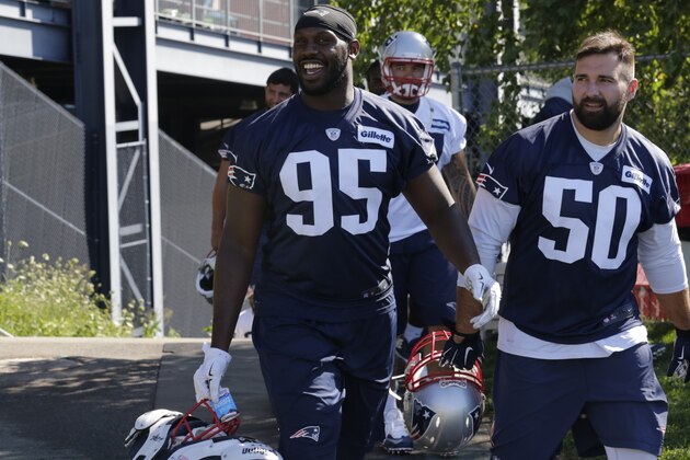 New England Patriots defensive ends Chandler Jones (95) and Rob Ninkovich (50) head to the practice field during an NFL football training camp in Foxborough, Mass., Friday, July 31, 2015.  From left are Chandler Jones (95), Rob Ninkovich (50), Jabaal Sheard (93) and Zach Moore (90). (AP Photo/Charles Krupa)