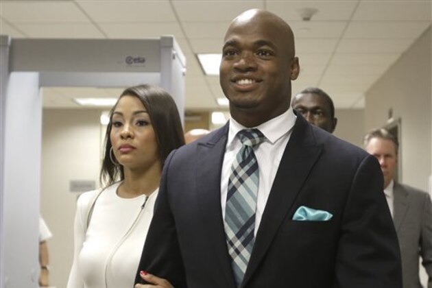FILE - In this  Nov. 4, 2014, file photo, Minnesota Vikings running back Adrian Peterson leaves the courthouse with his wife Ashley Brown Peterson in Conroe, Texas. A federal judge has cleared the way for Peterson to be reinstated. U.S. District Judge David Doty issued his order Thursday, Feb. 26, 2015, less than three weeks after hearing oral arguments. (AP Photo/Pat Sullivan, File)
