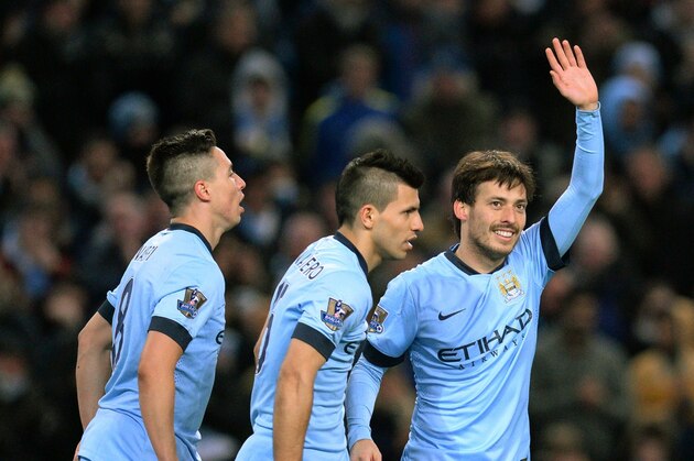 Manchester City's Spanish midfielder David Silva (R) celebrates scoring his team's fourth goal with Manchester City's French midfielder Samir Nasri (L) and Manchester City's Argentinian striker Sergio Aguero (C) during the English Premier League football match between Manchester City and Newcastle United at The Etihad Stadium in Manchester, Northern England on February 21, 2015. AFP PHOTO / OLI SCARFF
RESTRICTED TO EDITORIAL USE. NO USE WITH UNAUTHORIZED AUDIO, VIDEO, DATA, FIXTURE LISTS, CLUB/LEAGUE LOGOS OR LIVE SERVICES. ONLINE IN-MATCH USE LIMITED TO 45 IMAGES, NO VIDEO EMULATION. NO USE IN BETTING, GAMES OR SINGLE CLUB/LEAGUE/PLAYER PUBLICATIONS        (Photo credit should read OLI SCARFF/AFP/Getty Images)