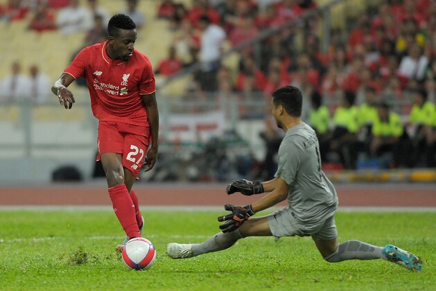 Liverpool football player Dovock Origi (L) dribbles the ball past Malaysia's goalkeeper Khairul Azhan Khalid during their friendly football match between English Premier League team Liverpool and Malaysia XI in Kuala Lumpur on July 24, 2015. AFP PHOTO / MOHD RASFAN        (Photo credit should read MOHD RASFAN/AFP/Getty Images)
