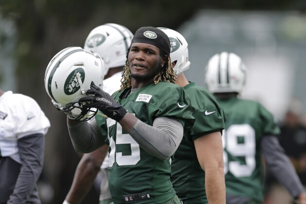 New York Jets outside linebacker Lorenzo Mauldin (55) puts his helmet on during drills at NFL football training camp, Thursday, July 30, 2015, in Florham Park, N.J. (AP Photo/Frank Franklin II)