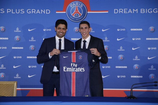 Paris Saint-Germain's (PSG) new Argentinian midfielder Angel Di Maria (R) and Paris Saint-Germain's Qatari president Nasser Al-Khelaifi pose with Di Maria's PSG jersey during his official presentation in Paris on August 6, 2015. Paris Saint-Germain completed the signing of Di Maria from Manchester United on a four-year deal, the French champions announced.  AFP PHOTO / KENZO TRIBOUILLARD        (Photo credit should read KENZO TRIBOUILLARD/AFP/Getty Images)